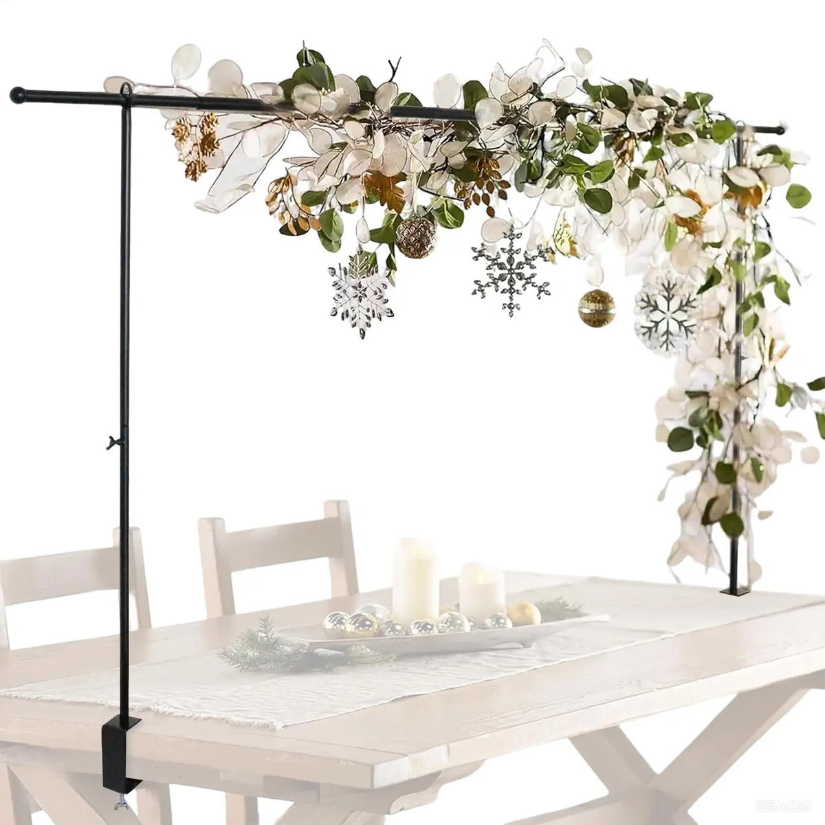 An adjustable balloon arch stand with clamps decorated with white and gold floral greenery for parties and events.