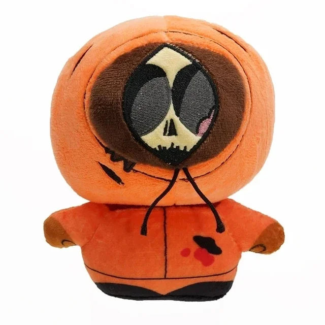 An orange plush toy resembling a stylized skull face with black and white markings.