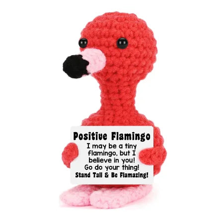 A handmade red plush knitting doll resembling a flamingo with a black beak.