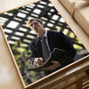 A man in a suit holds a notebook while looking out of a window, featured on a movie poster.