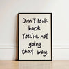 Black framed canvas wall art featuring the quote Don't look back. You're not going that way.