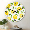 A round wall clock face decorated with yellow lemons and green leaves, featuring numbers 1 through 12.