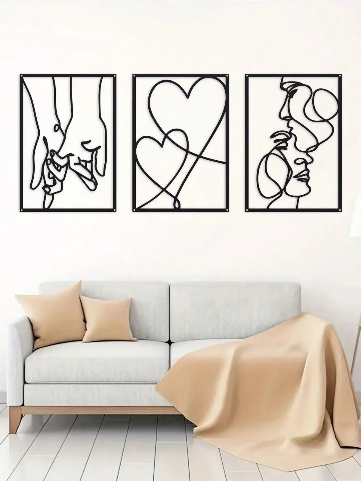 A set of three black line art prints depicting holding hands, a heart, and a profile of a face.