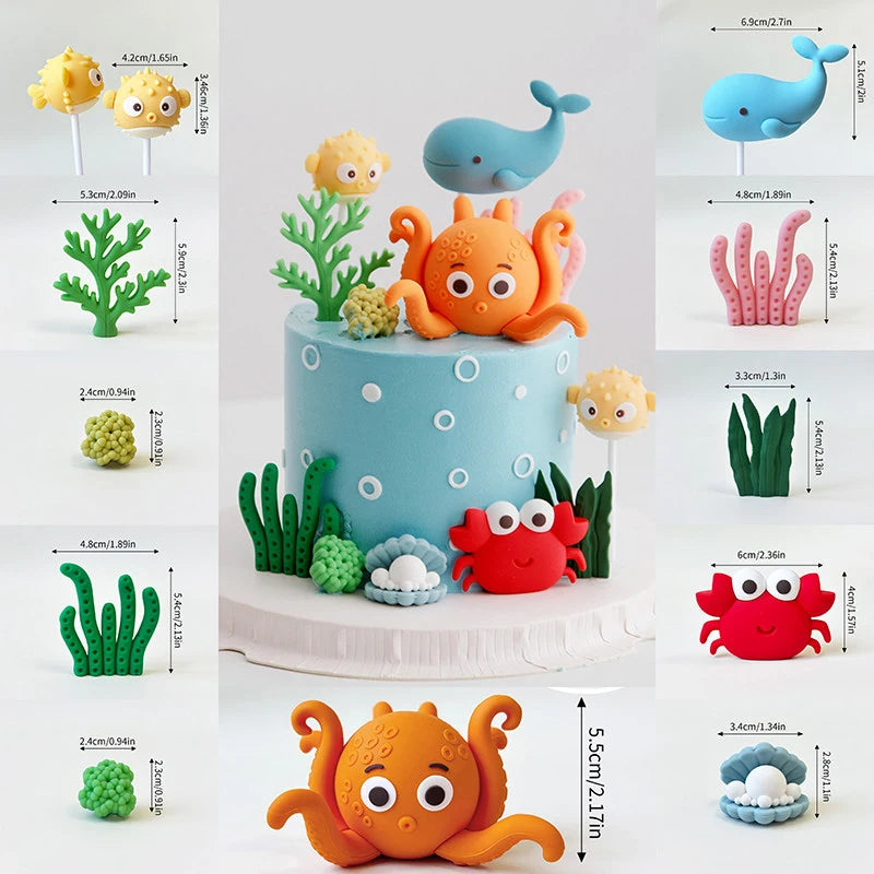 A set of ocean animal cake toppers featuring a blue whale, orange octopus, and green turtle figures.