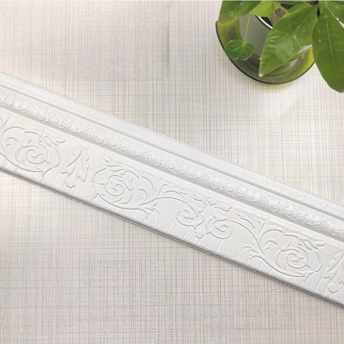 White self-adhesive 3D wall trim line with ornate scroll pattern for modern home decor