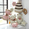 A stack of matte 3D heart love-you bear foil balloons in pink and beige, decorated for a birthday celebration.