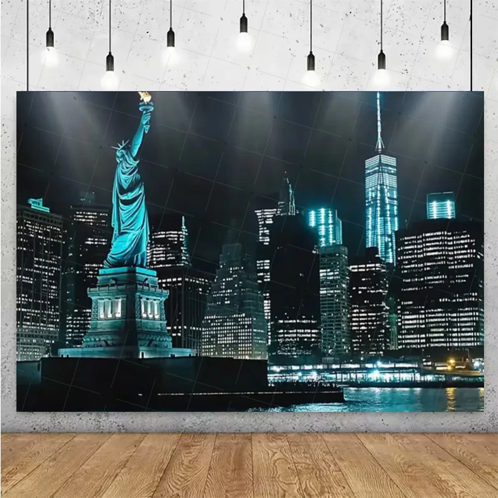A photograph of a statue against a dark night city skyline featuring illuminated high-rise buildings.