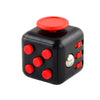 A black fidget cube with red dots and a red top, used as a stress relief toy.