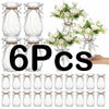 Six clear faceted diamond crystal plastic vases with natural twine tied around the neck.