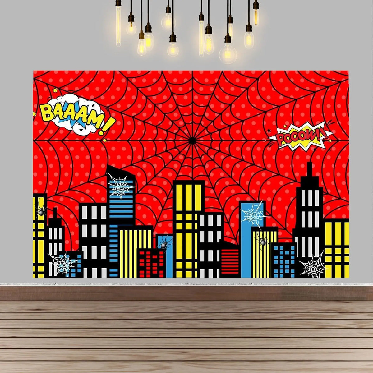A vibrant red spiderweb background featuring cartoon superhero text and silhouettes of city buildings.