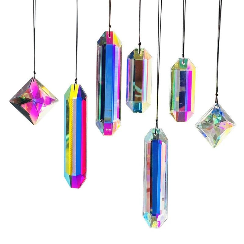 A set of seven colorful crystal prism sun catchers hanging by strings.