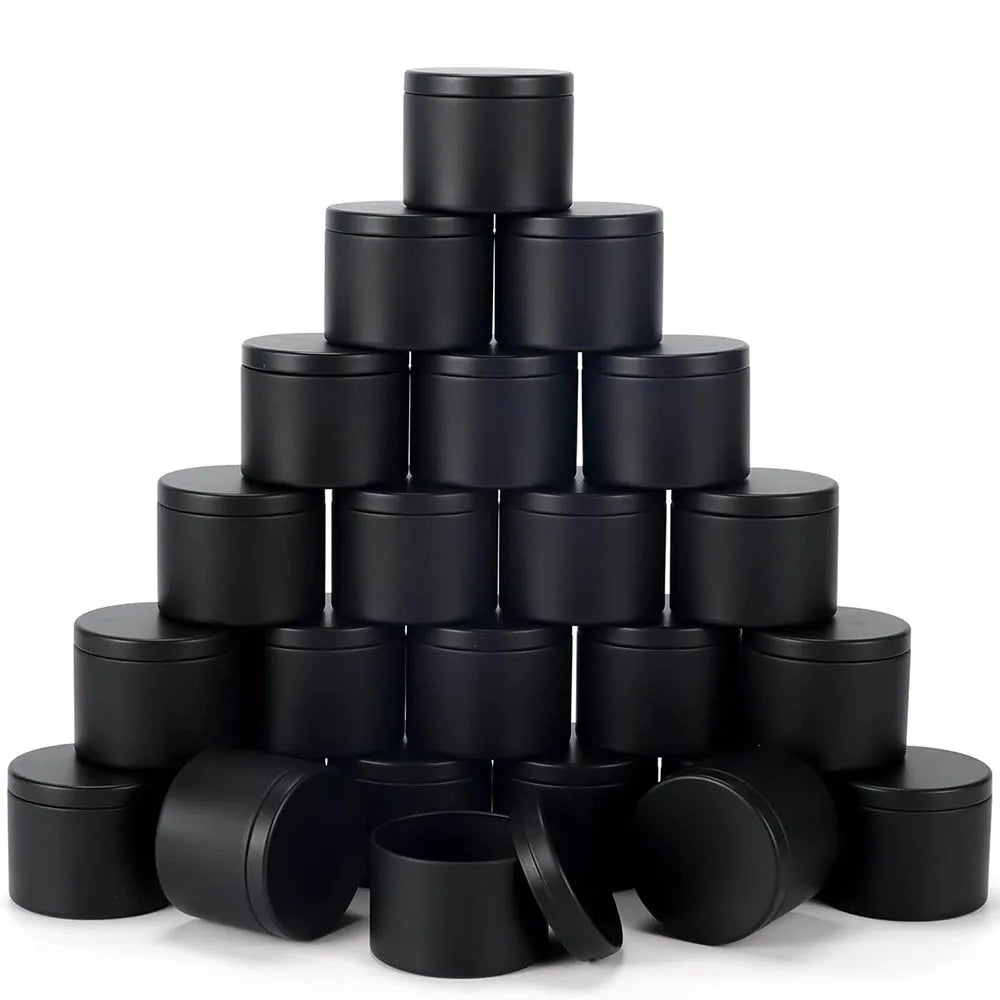 A stack of black candle tin containers with lids arranged in a pyramid shape.
