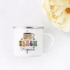 A white enamel mug with a design featuring a coffee cup and the words teach repeat
