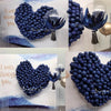 A close-up of blue latex balloons shaped like hearts and clusters displayed against a white background.