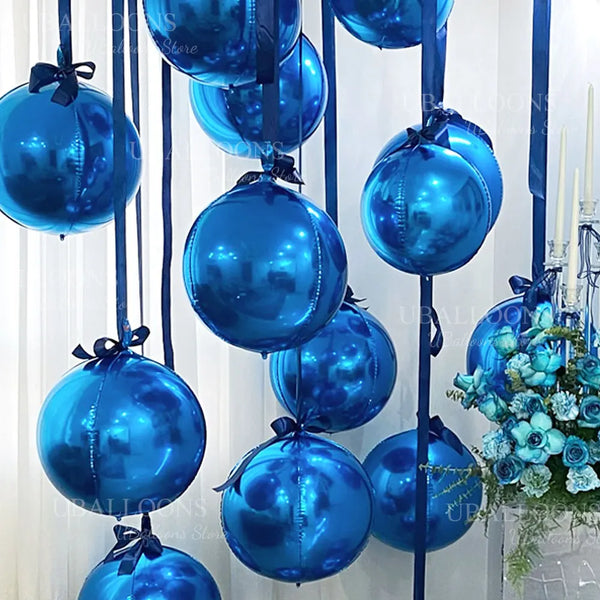 A vertical display of shiny royal blue foil balloons hanging from a string against a white background.