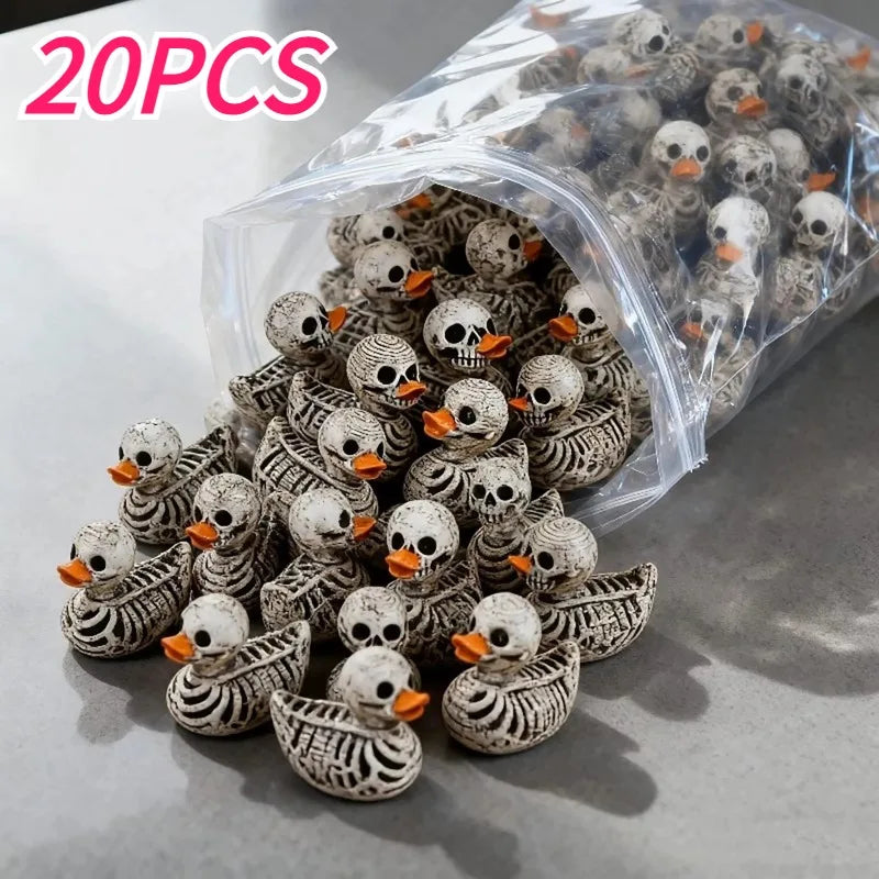A pile of 20 resin skull duck figurines in various shades of gray and white inside a clear plastic bag.