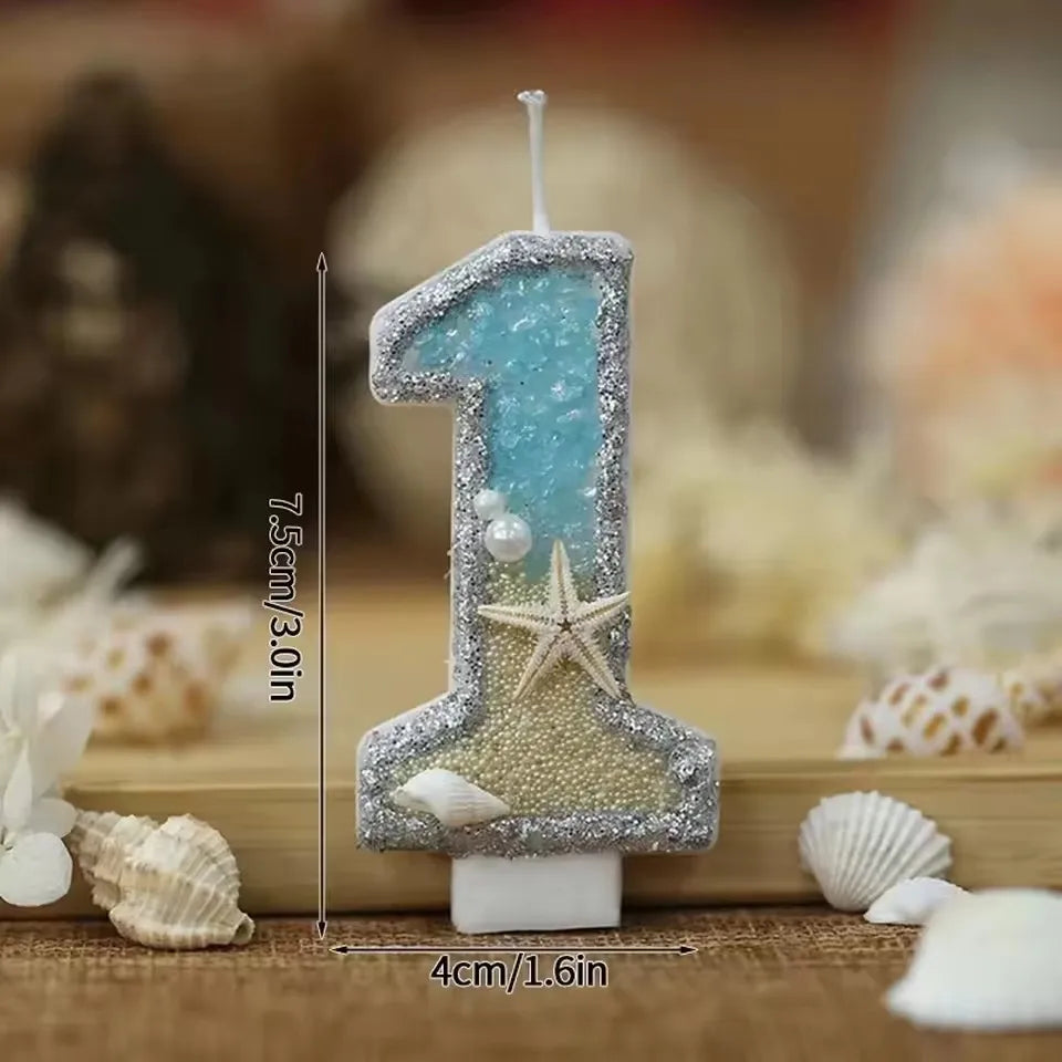 Glitter number cake topper shaped like the number one with a starfish design