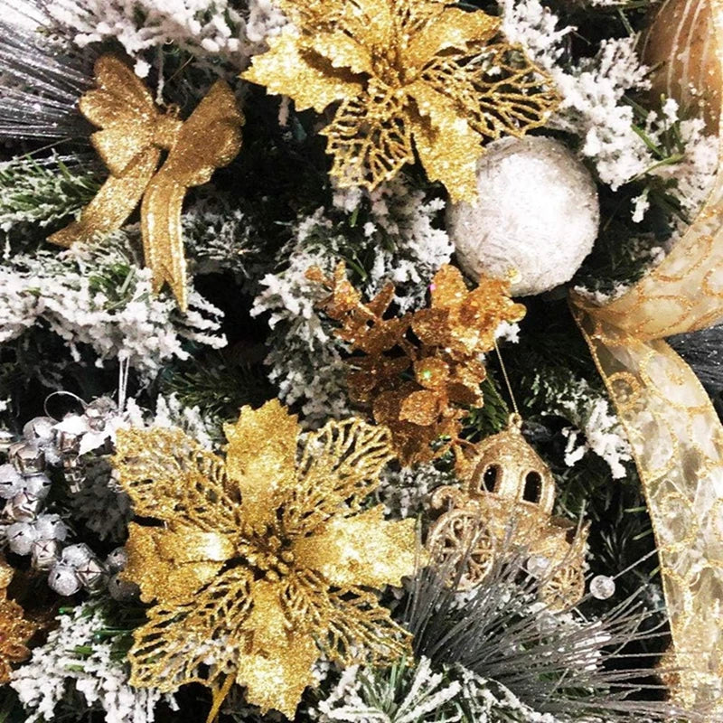 A close-up of artificial Christmas flowers with a gold sparkle finish decorated on a green fir branch covered in white flocki