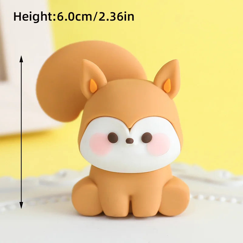 A small, round, light brown animal figure resembling a fox or canine, used as a cake topper.