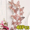 A set of 48 3D hollow butterfly wall stickers in gold and silver metallic decor displayed on a white brick wall.