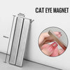 A silver rectangle cat eye magnet shown next to a ruler for scale, demonstrating its size.