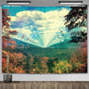 A vibrant tapestry featuring a landscape with lush green and autumnal foliage under a bright blue sky.