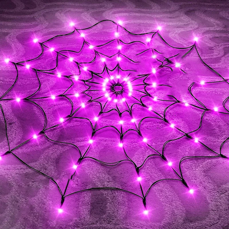 A glowing purple spider web pattern made of LED string lights on a textured surface.