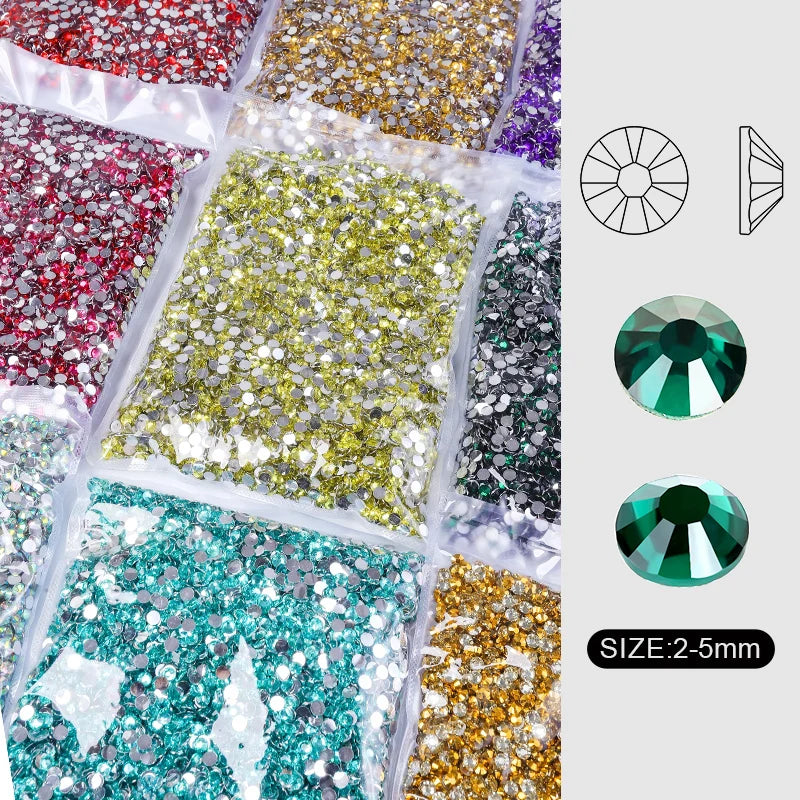 Assortment of round flatback resin rhinestones in various colors including gold, silver, green, and purple.