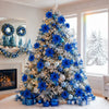 A large artificial Christmas tree decorated with blue glitter poinsettia flowers and silver ornaments in a bright room.