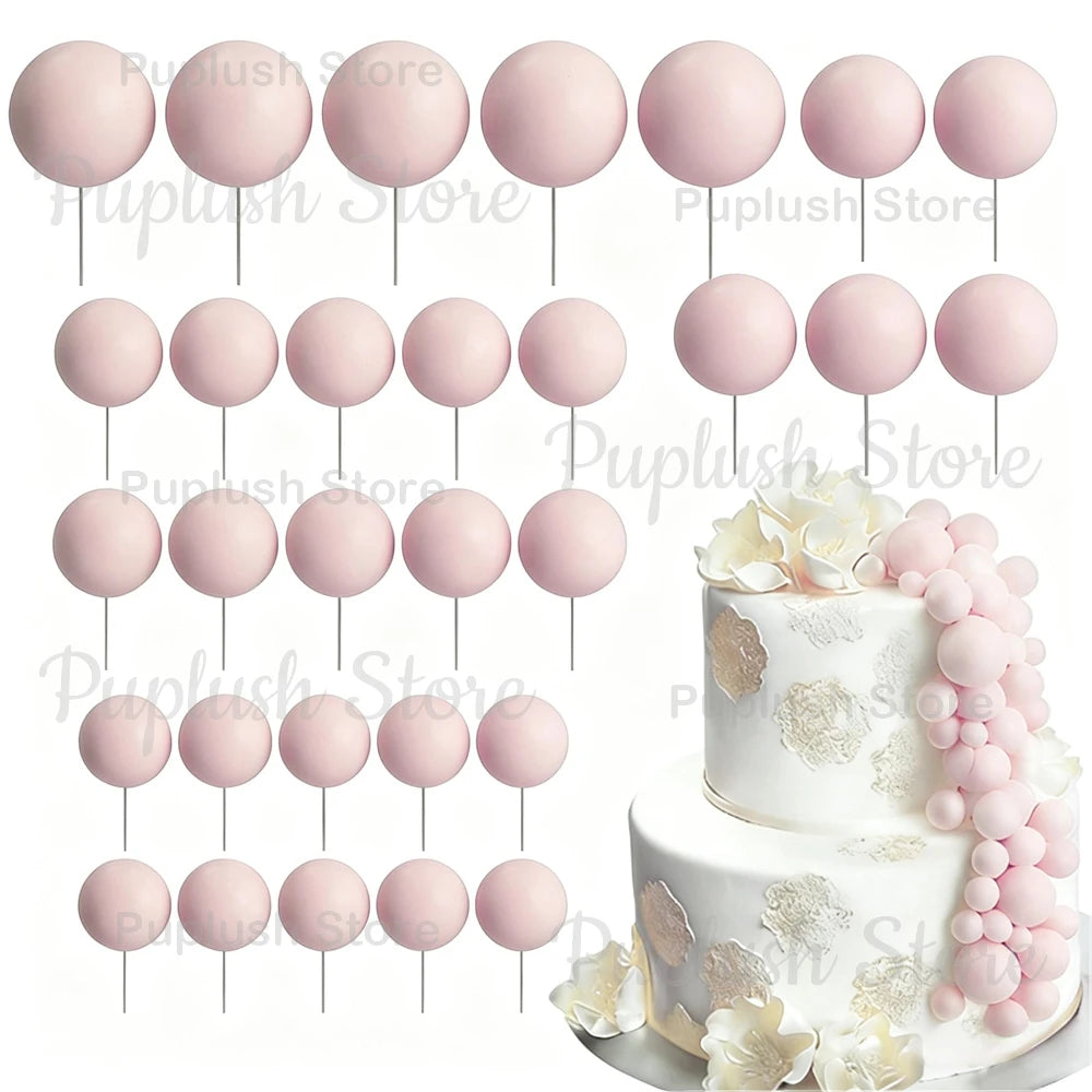A set of pink and white foam cake toppers, including round discs and floral accents.