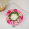 Hand-crocheted pink and green rose flower coasters arranged in a circular pattern.