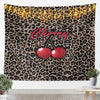 A tapestry wall hanging featuring a leopard print background with string lights and a cherry graphic.