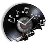 A black vintage vinyl record wall clock featuring a rotating record and musical notes.