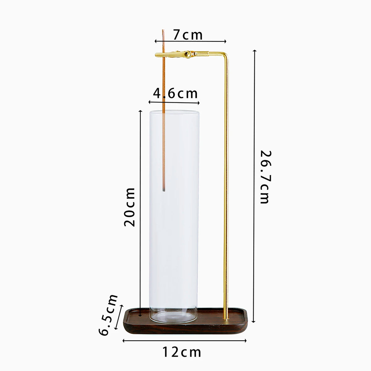 A tall glass incense holder with a brass rod and a wooden base for burning incense.