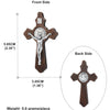 A wooden crucifix pendant showing the front and back sides of a St. Benedict cross.