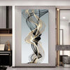 Abstract wall art featuring swirling gold and black ribbons on a light gray background.
