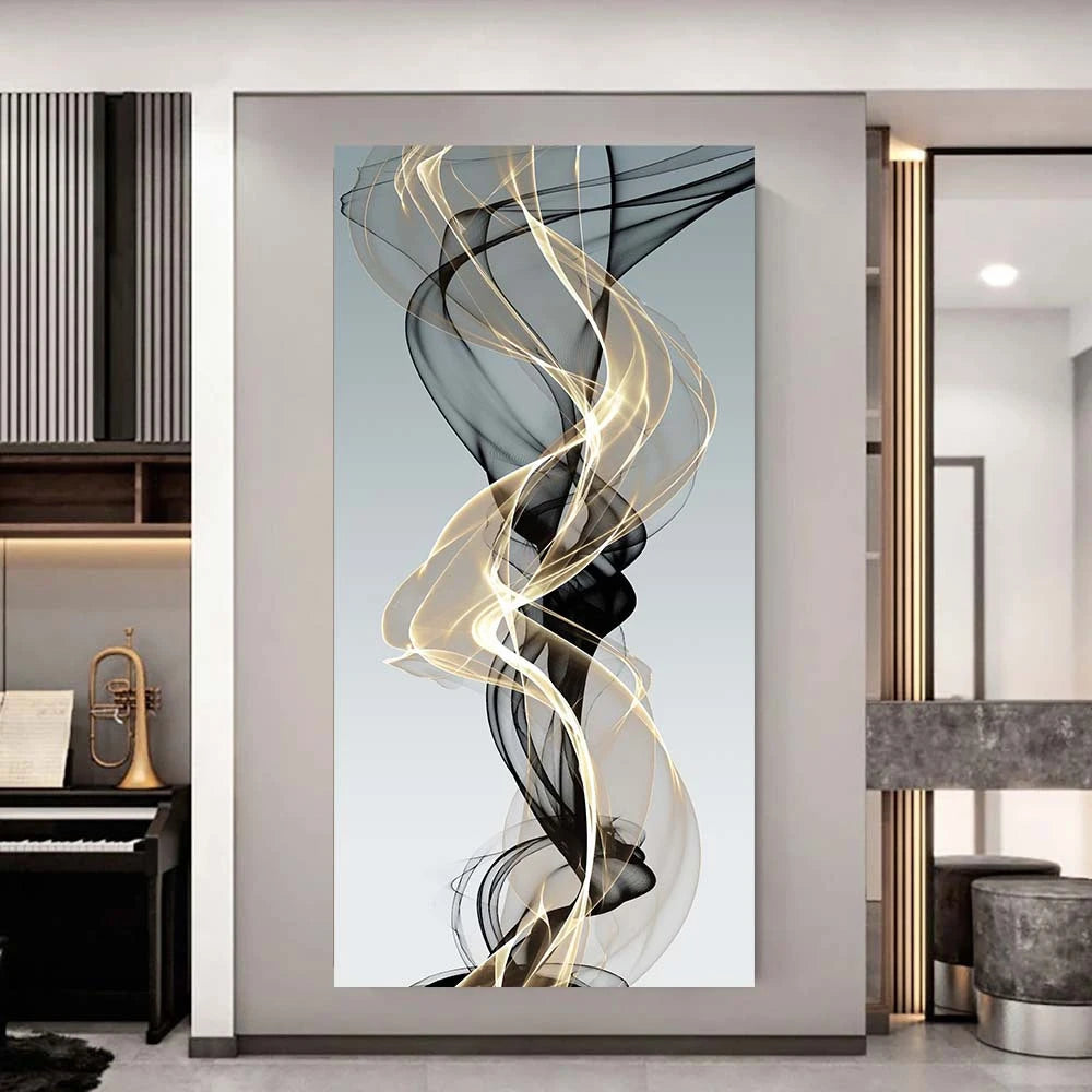 Abstract wall art featuring swirling gold and black ribbons on a light gray background.