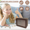 A wooden money box with a counter is shown next to coins and paper money on a white surface.