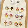 Una lámina de arte de uñas con varios encantos de tortugas mini coloridas para uñas.