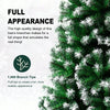 Close-up of a green artificial Christmas tree with white flocked branches.