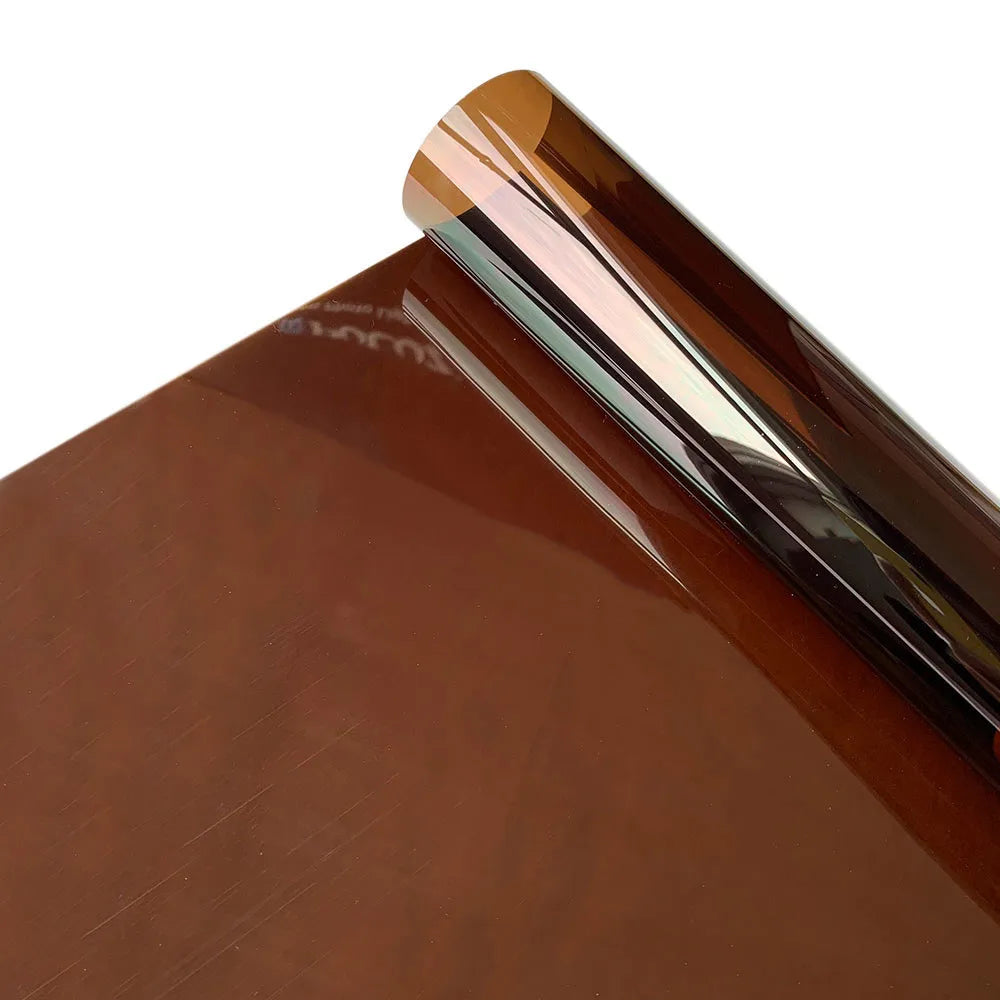Close-up of a decorative stained glass window film in a brown tone with a glossy, reflective edge.