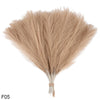 A bundle of light beige artificial pampas grass reeds used for home and event decoration.