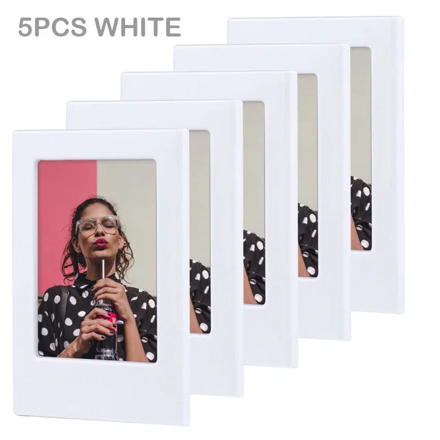 Five white magnetic photo frames displayed in a row against a white background.