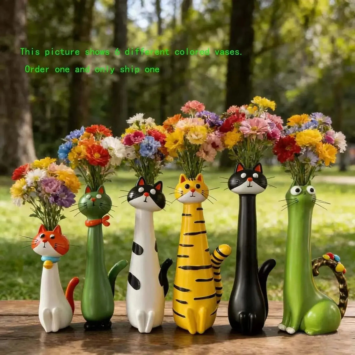 Six cat-shaped resin vases holding colorful dried flowers