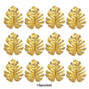 Twelve artificial golden tropical palm leaves used for party decoration