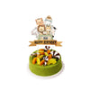 A tiered birthday cake decorated with jungle safari animal figures and a happy birthday banner