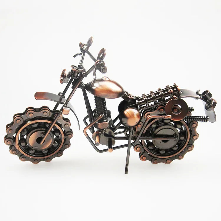 A vintage iron motorcycle figurine with bronze and black metal components.