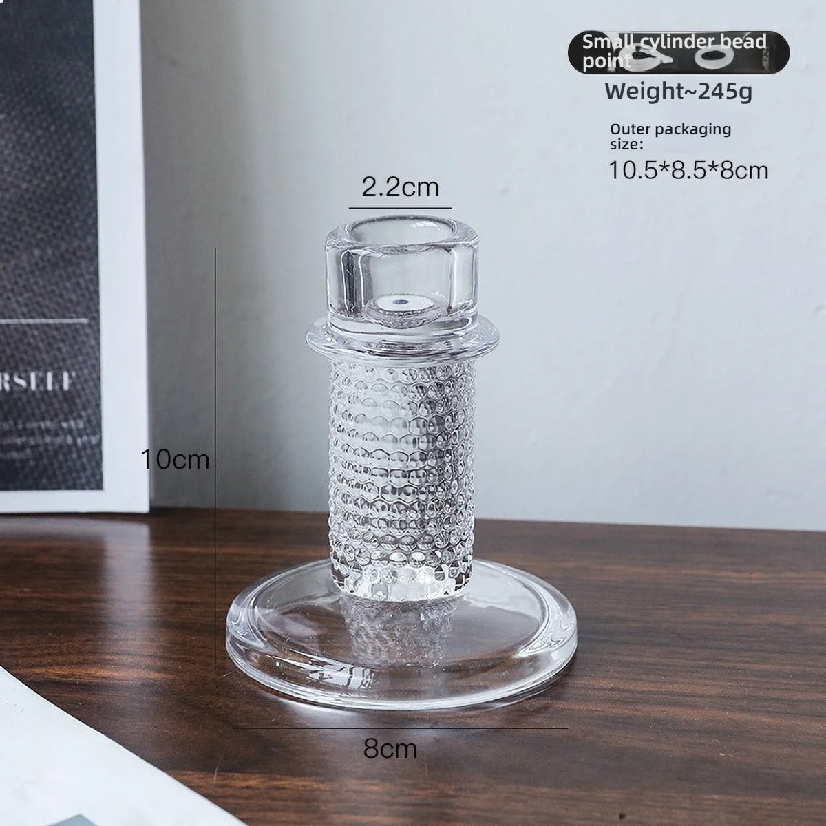 Elegant clear glass pillar candle holder with a textured glass body and a circular base.