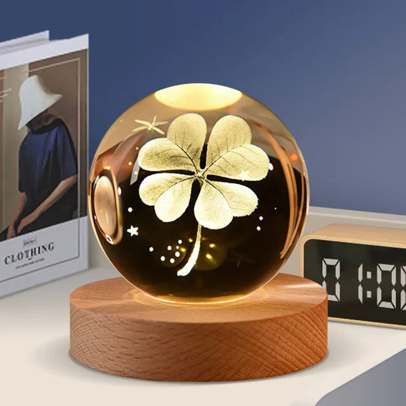 A golden shamrock design is visible inside a round glass crystal ball resting on a wooden base.