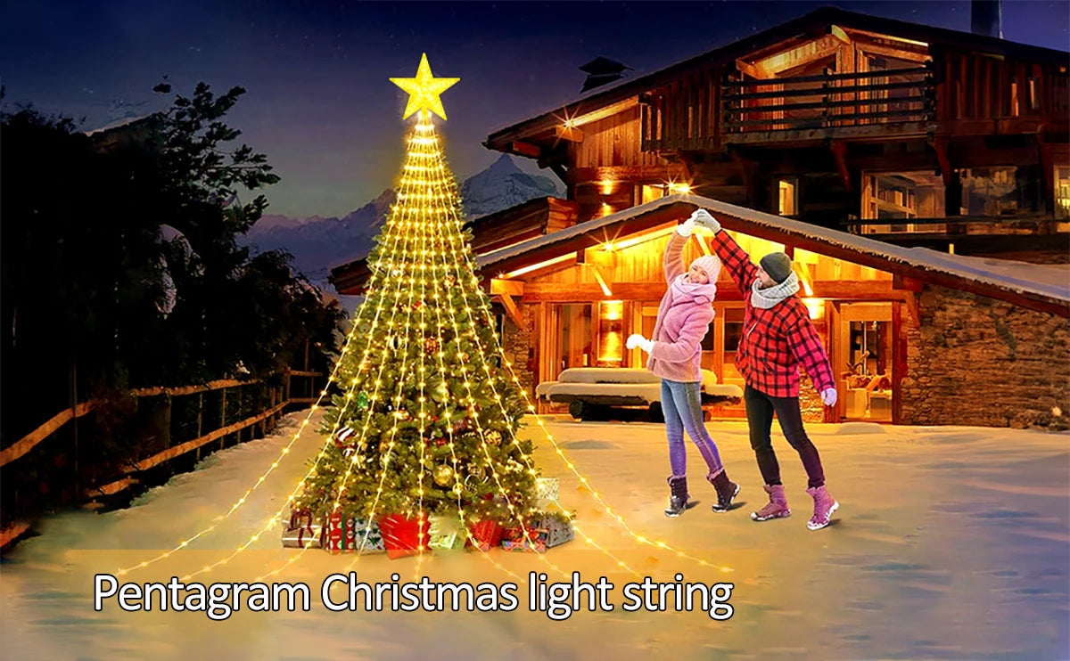 A decorated Christmas tree with a star topper is illuminated by a light string in a snowy outdoor setting.